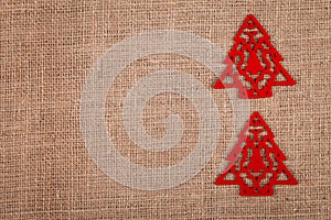 Two Christmas trees on burlap