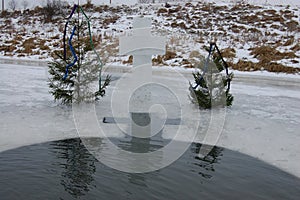 Two Christmas trees with a cross on the ice