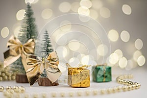 Two Christmas trees decorated and gifts for the new year on the bokeh background, new year mood 2021