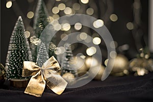 Two Christmas trees decorated and gifts for the new year on the bokeh background, new year mood 2021