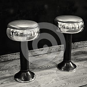 Two chrome and black stools