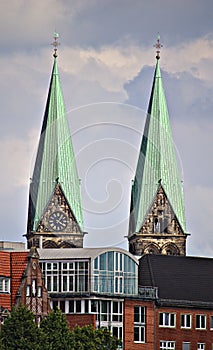 Two church spires over city skyline