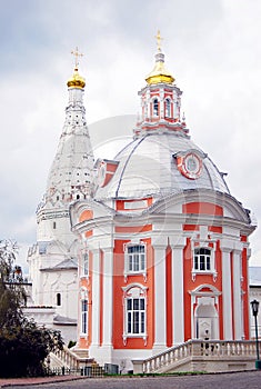 Two churches in Trinity Sergius Lavra decorated by golden crosses.