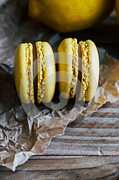 Two citron macaroons on a wooden background