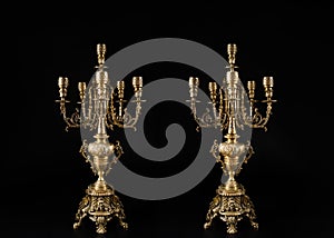 Two classic bronze chandeliers on a black background, ancient candlesticks studio photo, antique bronze candlesticks isolated, bra