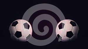 Two classic soccer balls, one in front another, isolated on a black background with copy space for match announcements and