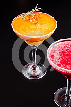 Two classic and strawberry margarita, white and red alcoholic cocktail with decoration of salt on the edge of the glass