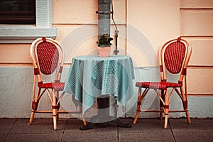 Two classic style chairs and table outdoors