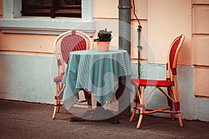 Two classic style chairs and table outdoors