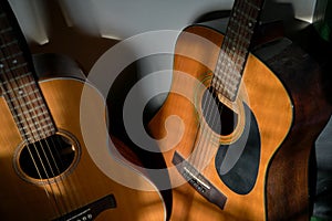 Two classical guitars by the wall