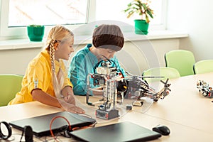 Two classmates building models using construction set.