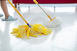 Two cleaners with mop cleaning marble floor outdoors. Cleaning service