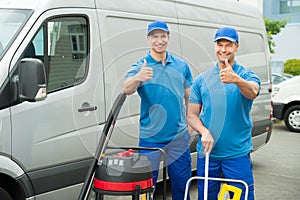 Two Cleaners Standing With Cleaning Equipments