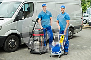 Two Cleaners Standing With Cleaning Equipments