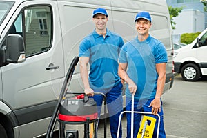 Two Cleaners Standing With Cleaning Equipments