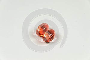 Two clear red soft gelatine capsules 2.