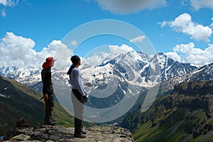 Two climbers looking at the mountains