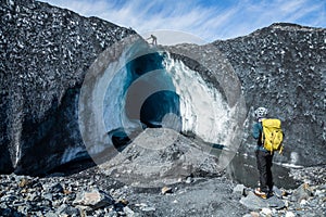 Two climbing guides exploring a huge ice cave on the Matanuska Glacier in Alaska