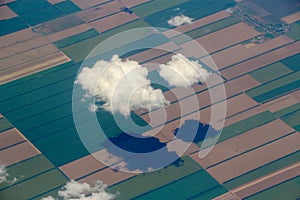 Two clouds and agriculture fields