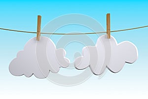 Two clouds hanging by clothes peg on a clothesline