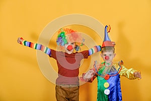 Two clowns hug and wave their arms around