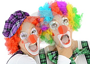 Two clowns made up in costume for carnival scream and shout out loud