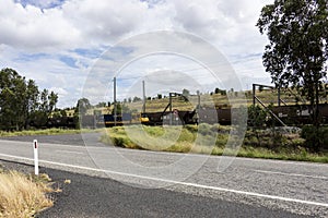 Two coal trains passing on electric railway lines.