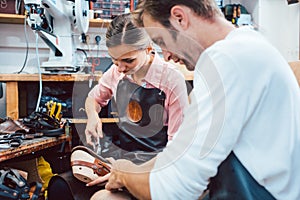 Two cobblers working together in the workshop