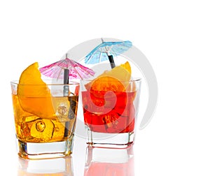Two cocktail with orange slice and umbrella on top isolated on white background