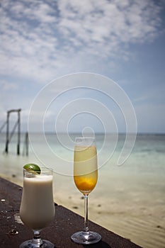 Two cocktails in front of a fringing reef in Queensland, Australia