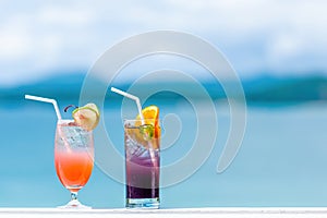 Two cocktails in luxury resort in sunny summer day. Mocktail drinks with straw in tropical luxurious hotel. Travel