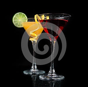 Two cocktails red cosmopolitan cocktail on a black background