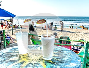 Two cocktails on a sun table with view of Mexican beach in Sayulita