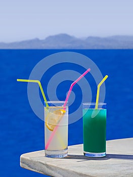 Two cocktails on table at beach