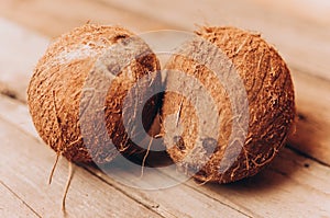 two coconuts lie on a wooden table