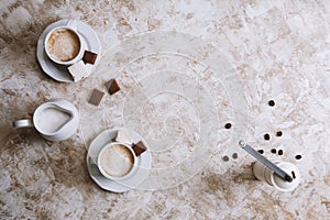 Two coffee cups on a bright vintage background