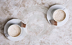 Two coffee cups on a bright vintage background