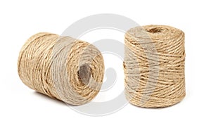 Two coil bobbins of burlap jute twine over white