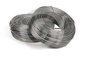 Two coils of galvanized wires lying on white background