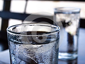 Two cold water glass with ice cubes, Water drops, Close up & Macro shot, Selective focus, Healthy Drink concept
