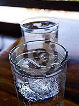 Two cold water glass with ice cubes, Water drops, Close up & Macro shot, Selective focus, Healthy Drink concept