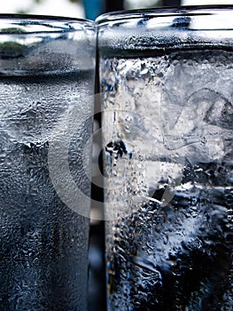 Two cold water glass with ice cubes, Water drops, Close up & Macro shot, Selective focus, Healthy Drink concept