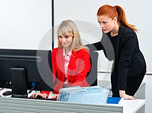 Two colleague worker in office with computer