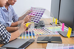 Two colleagues creative graphic designer working on color selection and drawing on graphics tablet at workplace, Color swatch