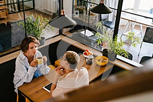 Two colleagues discussing business details during coffee break