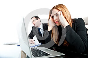 Two colleagues looking stressed whilst at work