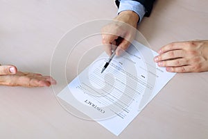 Two colleagues is signing a contract, business meeting in the office