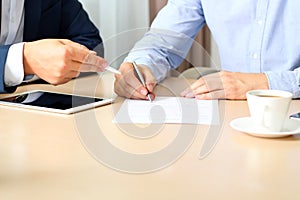 Two colleagues is signing a contract, business meeting in the office