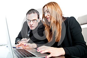 Two colleagues working together on a laptop