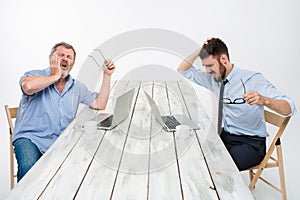 The two colleagues working together at office on white background